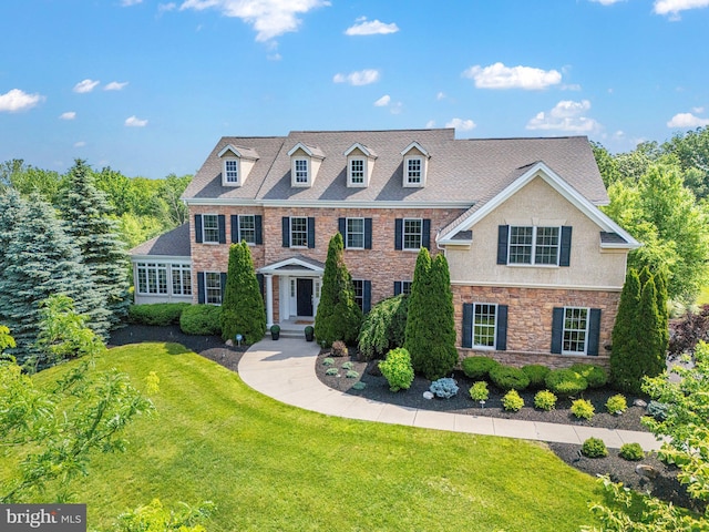 228 Chandler Way, Perkasie, PA 18944 - colonial-style house with a front yard, stone siding, and stucco siding