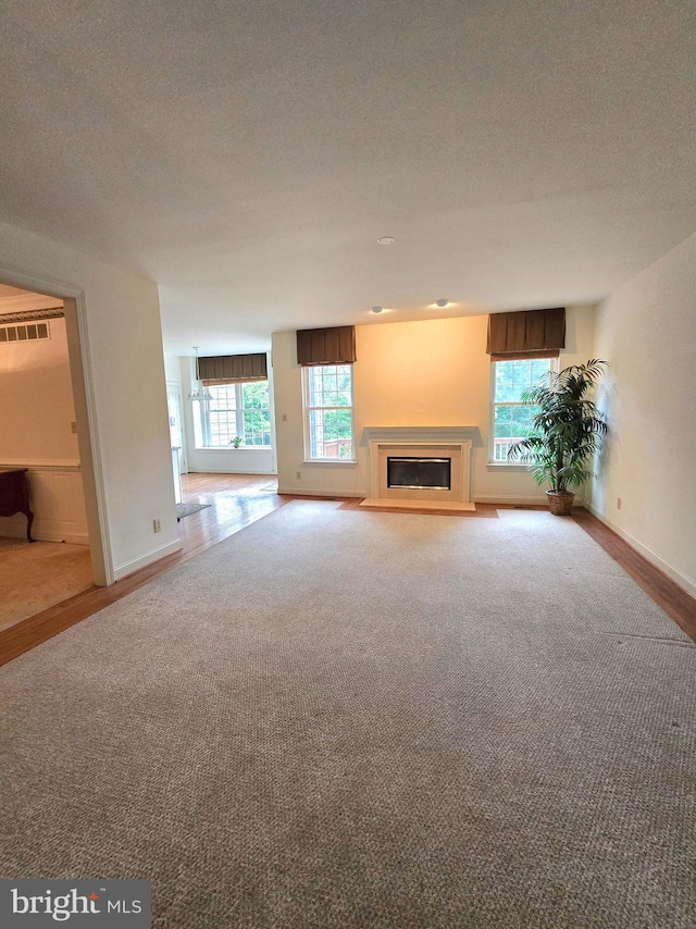 721 Kincaid Mills Ln, Wallingford, PA 19086 - unfurnished living room with a glass covered fireplace, carpet, and a textured ceiling