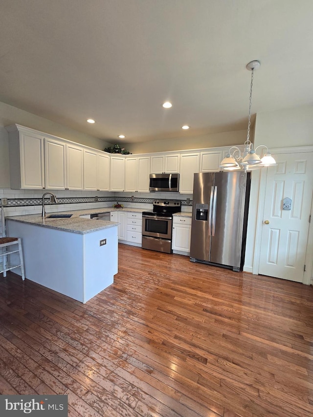 721 Kincaid Mills Ln, Wallingford, PA 19086 - kitchen with stainless steel appliances, a peninsula, white cabinets, dark wood-type flooring, and recessed lighting