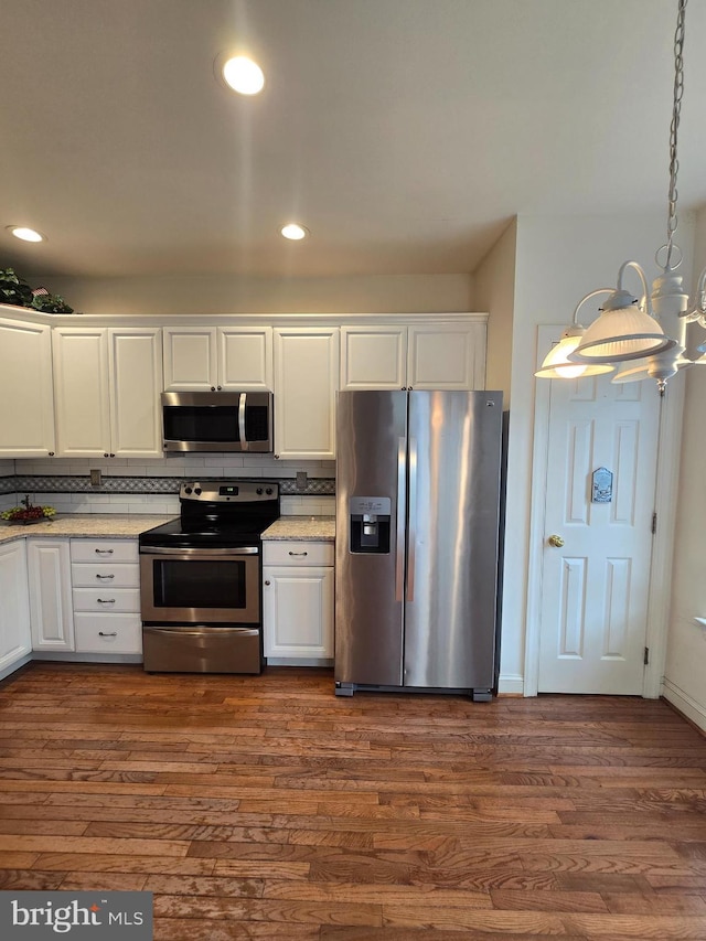 721 Kincaid Mills Ln, Wallingford, PA 19086 - kitchen featuring appliances with stainless steel finishes, white cabinetry, dark wood-style flooring, tasteful backsplash, and recessed lighting