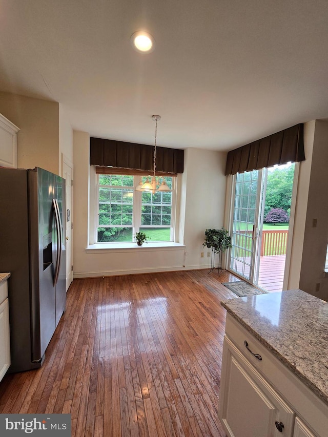 721 Kincaid Mills Ln, Wallingford, PA 19086 - kitchen featuring stainless steel fridge with ice dispenser, wood-type flooring, white cabinets, and light stone countertops