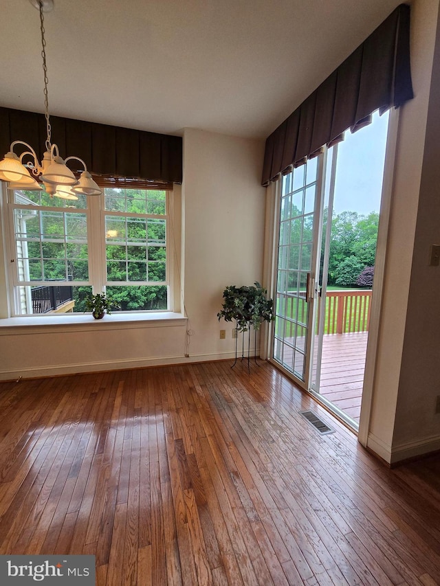 721 Kincaid Mills Ln, Wallingford, PA 19086 - unfurnished dining area with wood-type flooring and a chandelier