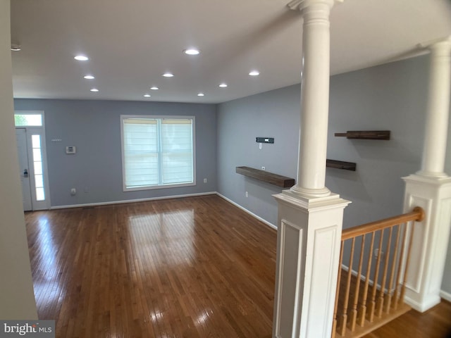 8726 Wadebrook Ter, Springfield, VA 22153 - unfurnished living room featuring decorative columns, wood finished floors, and recessed lighting