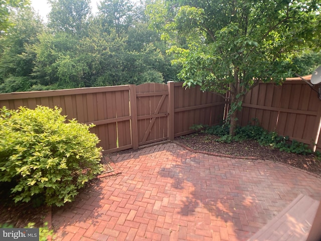 8726 Wadebrook Ter, Springfield, VA 22153 - fenced backyard featuring a gate and a patio