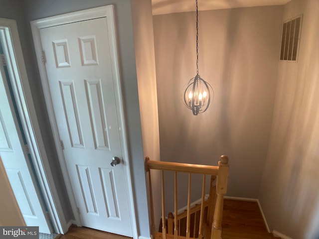 8726 Wadebrook Ter, Springfield, VA 22153 - staircase featuring a chandelier, wood finished floors, and baseboards