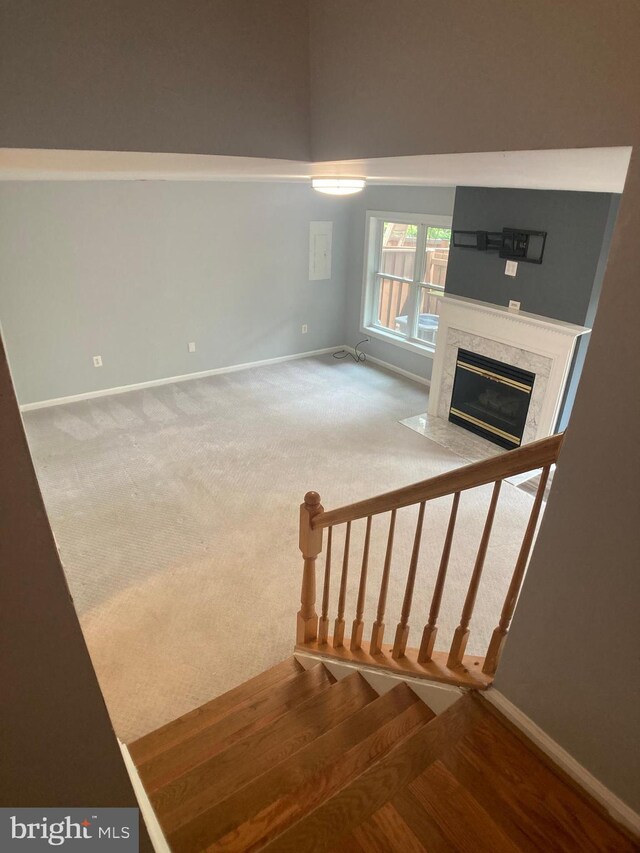 8726 Wadebrook Ter, Springfield, VA 22153 - stairs featuring baseboards, a fireplace, and carpet floors