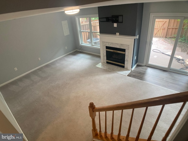 8726 Wadebrook Ter, Springfield, VA 22153 - unfurnished living room featuring baseboards, a high end fireplace, and carpet