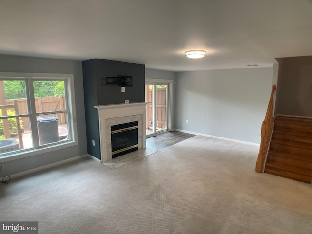 8726 Wadebrook Ter, Springfield, VA 22153 - unfurnished living room featuring stairs, healthy amount of natural light, and baseboards