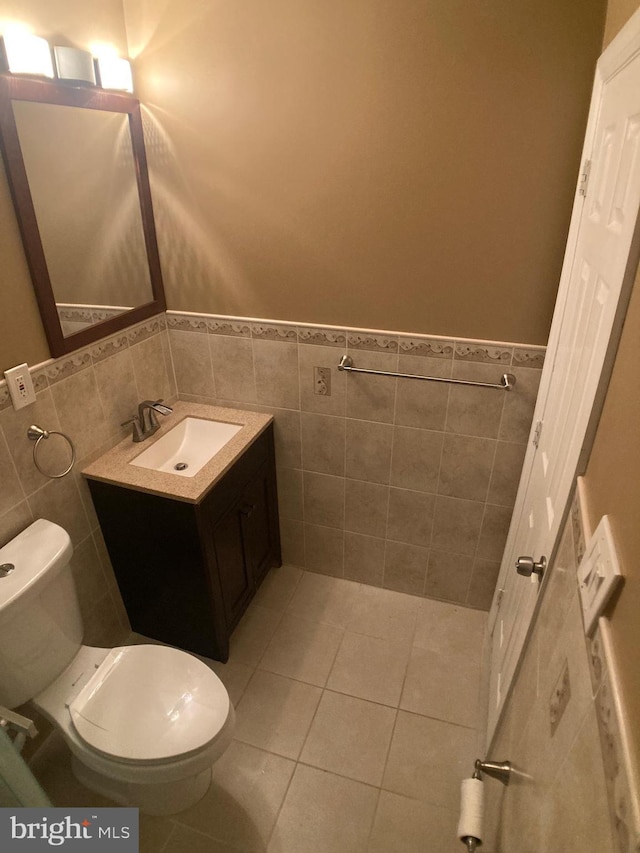8726 Wadebrook Ter, Springfield, VA 22153 - bathroom with toilet, tile walls, wainscoting, vanity, and tile patterned flooring