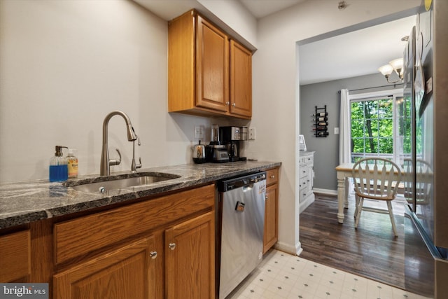 2009 Creekside Ct Unit 28, Warrington, PA 18976 - kitchen with stainless steel dishwasher, a sink, brown cabinets, light flooring, and dark stone counters