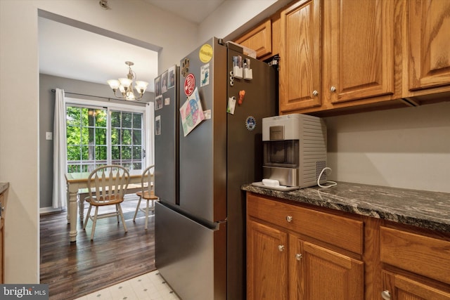 2009 Creekside Ct Unit 28, Warrington, PA 18976 - kitchen featuring freestanding refrigerator, brown cabinets, a chandelier, and dark stone countertops