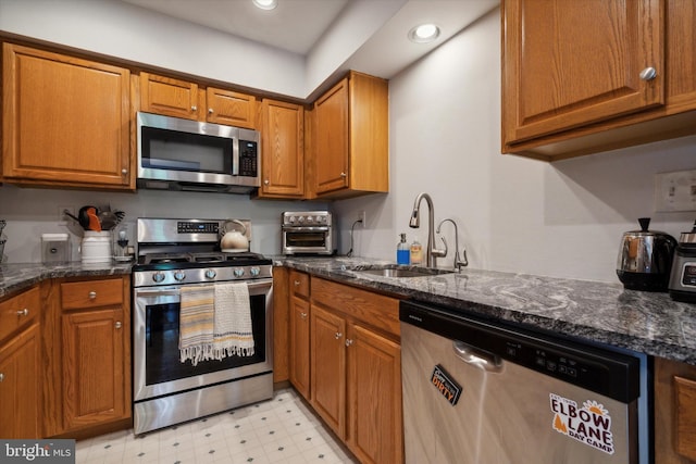 2009 Creekside Ct Unit 28, Warrington, PA 18976 - kitchen featuring appliances with stainless steel finishes, a sink, brown cabinets, light flooring, and recessed lighting