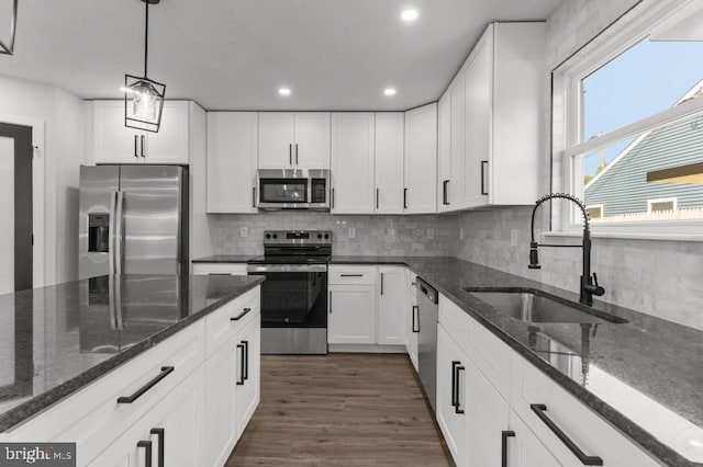 411 New York Ave, Croydon, PA 19021 - kitchen featuring stainless steel appliances, a sink, white cabinetry, dark stone counters, and tasteful backsplash