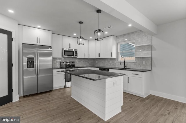 411 New York Ave, Croydon, PA 19021 - kitchen with appliances with stainless steel finishes, a sink, decorative backsplash, white cabinetry, and recessed lighting