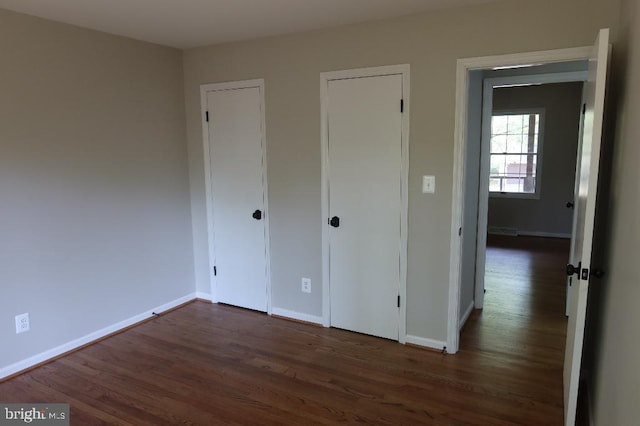 21605 Columbia St, Lexington Park, MD 20653 - unfurnished bedroom featuring dark wood-type flooring and baseboards
