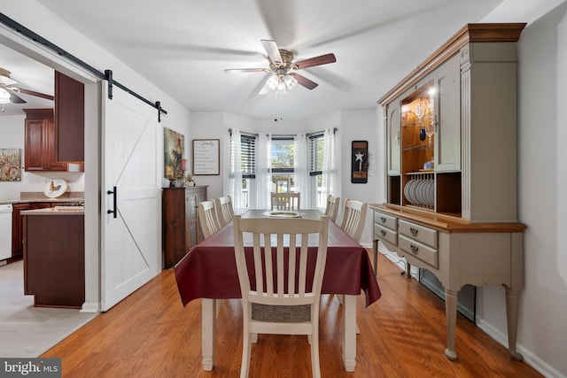 470 N Nautilus Dr, Manahawkin, NJ 08050 - dining room with ceiling fan, a barn door, and light wood-style flooring