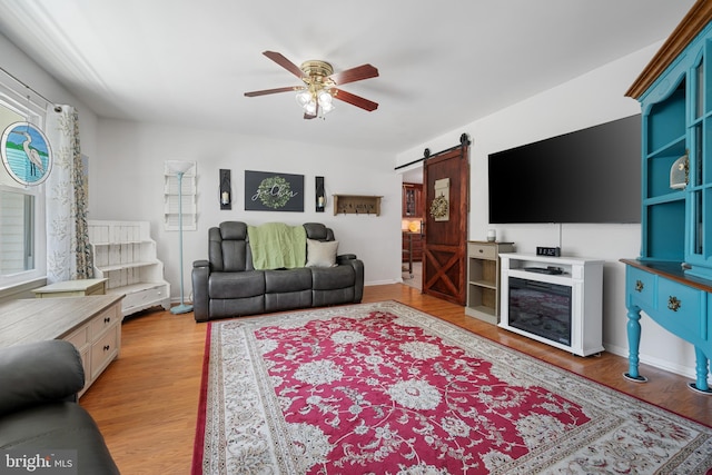 470 N Nautilus Dr, Manahawkin, NJ 08050 - living area with a barn door, a ceiling fan, light wood-style flooring, and plenty of natural light