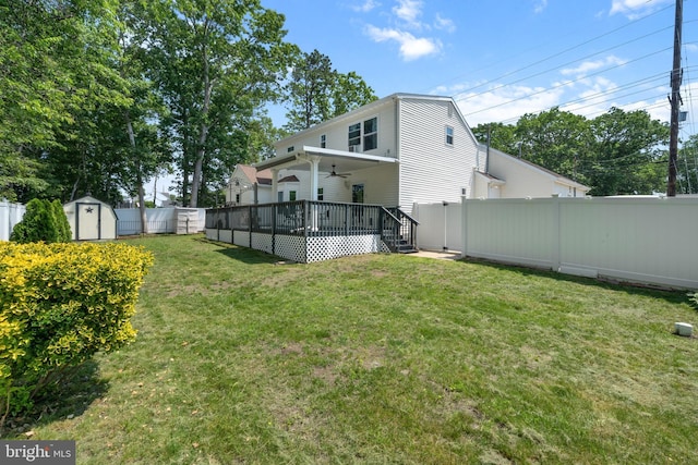 470 N Nautilus Dr, Manahawkin, NJ 08050 - rear view of house with ceiling fan, a fenced backyard, and a storage shed