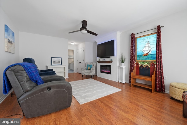 470 N Nautilus Dr, Manahawkin, NJ 08050 - living room featuring wood finished floors, a glass covered fireplace, and ceiling fan