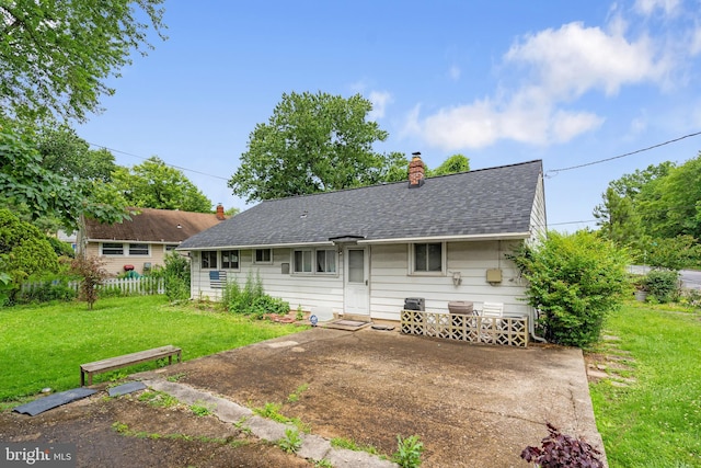 2000 Longview Ct, Baltimore, MD 21237 - back of property with a chimney, a lawn, and roof with shingles
