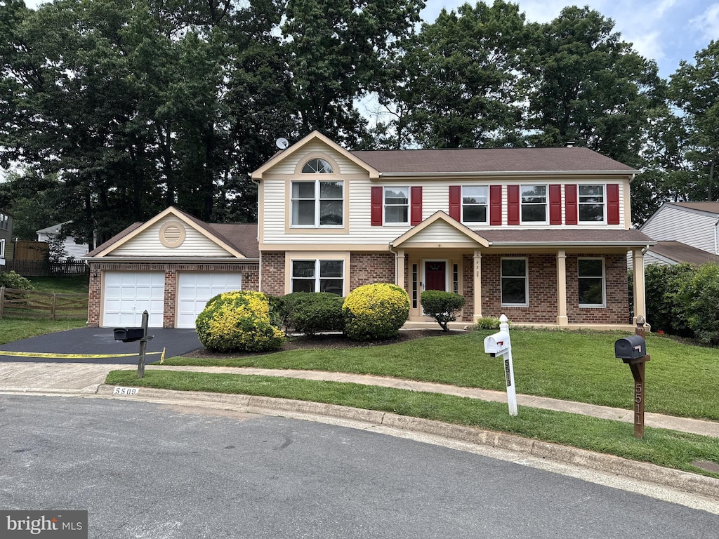 5509 Yellow Rail Ct, Fairfax, VA 22032 - view of front of house with an attached garage, asphalt driveway, and brick siding