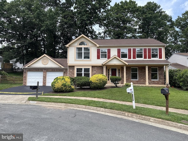 5509 Yellow Rail Ct, Fairfax, VA 22032 - view of front of house with an attached garage, asphalt driveway, and brick siding