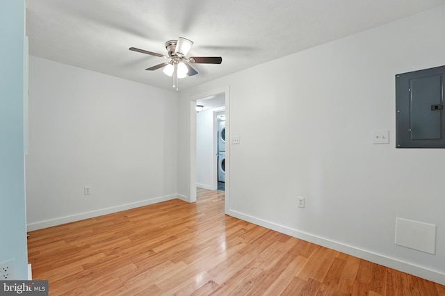 14 Summit Point Dr, Front Royal, VA 22630 - unfurnished room with electric panel, stacked washer / drying machine, a ceiling fan, and light wood finished floors
