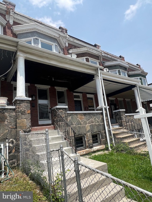 2732 Riggs Ave, Baltimore, MD 21216 - view of front of house featuring a porch, brick siding, and a gate