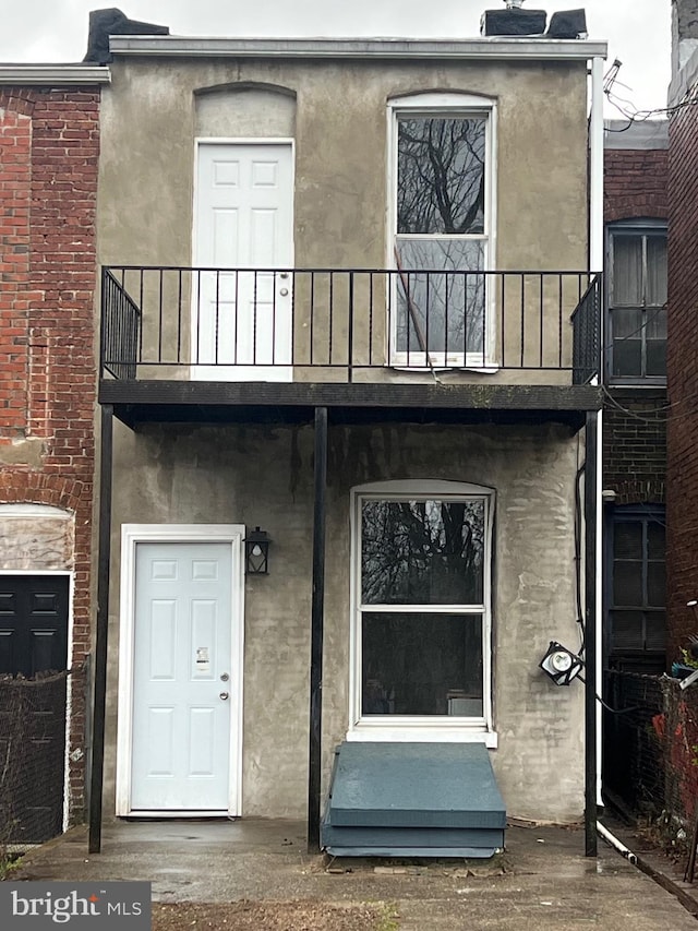 2732 Riggs Ave, Baltimore, MD 21216 - back of property featuring a balcony and stucco siding