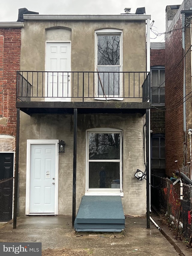 2732 Riggs Ave, Baltimore, MD 21216 - doorway to property with a balcony and stucco siding
