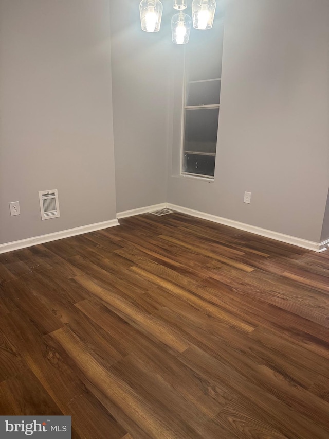 2732 Riggs Ave, Baltimore, MD 21216 - unfurnished dining area featuring dark wood-style floors and a chandelier