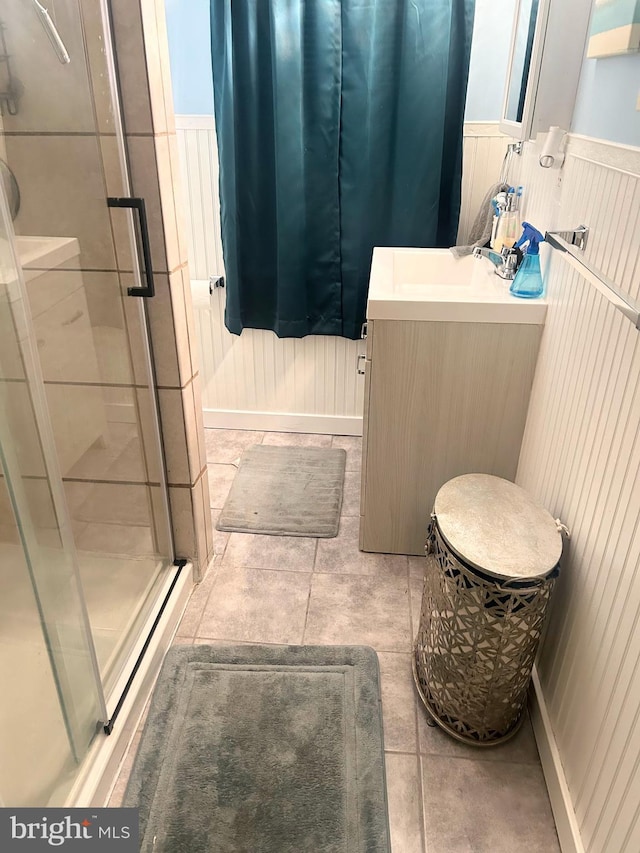6540 Parnell Ave, Baltimore, MD 21222 - bathroom with vanity, a stall shower, wainscoting, and tile patterned flooring