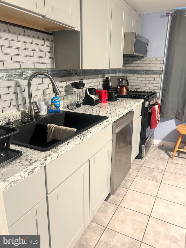 6540 Parnell Ave, Baltimore, MD 21222 - kitchen with stainless steel appliances, backsplash, and light tile patterned floors