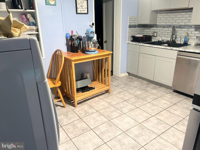 6540 Parnell Ave, Baltimore, MD 21222 - kitchen featuring dishwasher, tasteful backsplash, light tile patterned floors, refrigerator, and light stone countertops