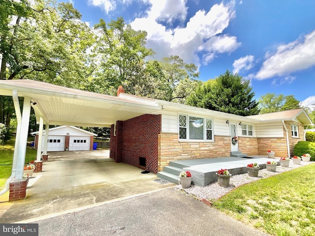 4647 Leonardtown Rd, Waldorf, MD 20601 - view of front facade featuring driveway, an outdoor structure, stone siding, an attached carport, and a front lawn