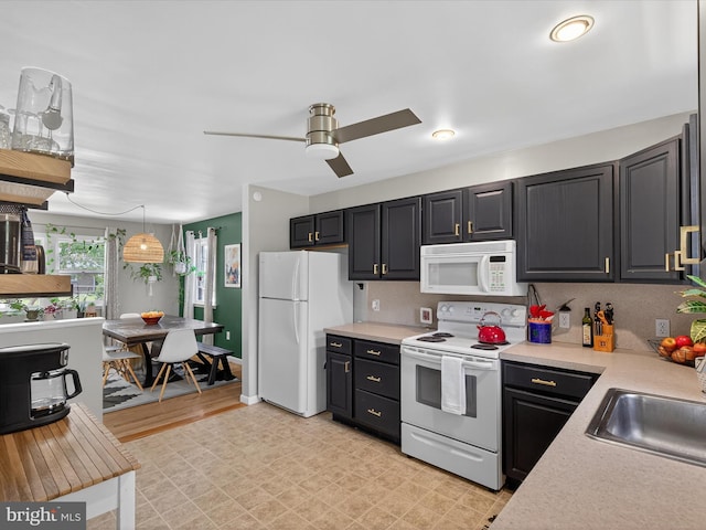 303 Stevens Ave, Reading, PA 19608 - kitchen featuring white appliances, light countertops, a ceiling fan, a sink, and pendant lighting