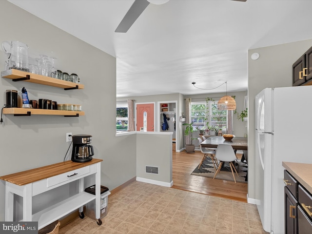 303 Stevens Ave, Reading, PA 19608 - kitchen featuring freestanding refrigerator, ceiling fan, baseboards, and light countertops