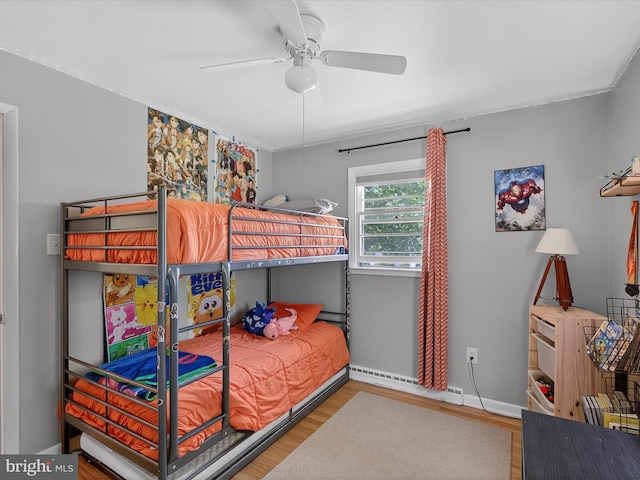 303 Stevens Ave, Reading, PA 19608 - bedroom with wood finished floors, baseboard heating, baseboards, and a ceiling fan