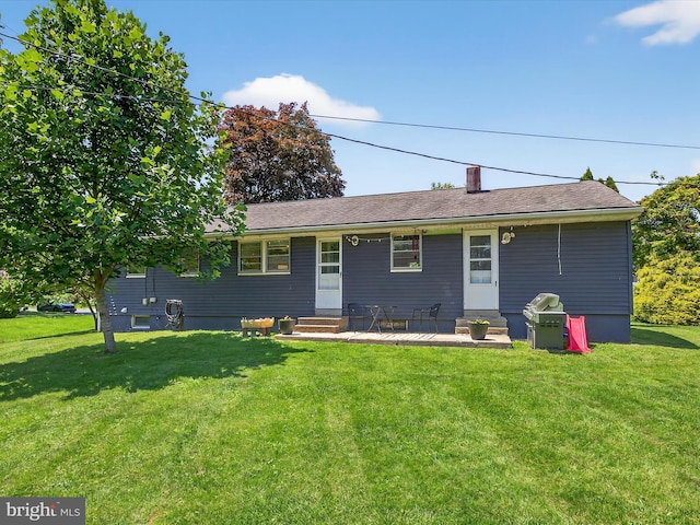 303 Stevens Ave, Reading, PA 19608 - view of front of house featuring entry steps, a front yard, and a chimney