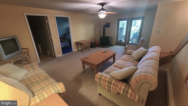 1725 Loop Rd, Franklin, WV 26807 - living area with a wood stove, carpet, ceiling fan, and baseboards