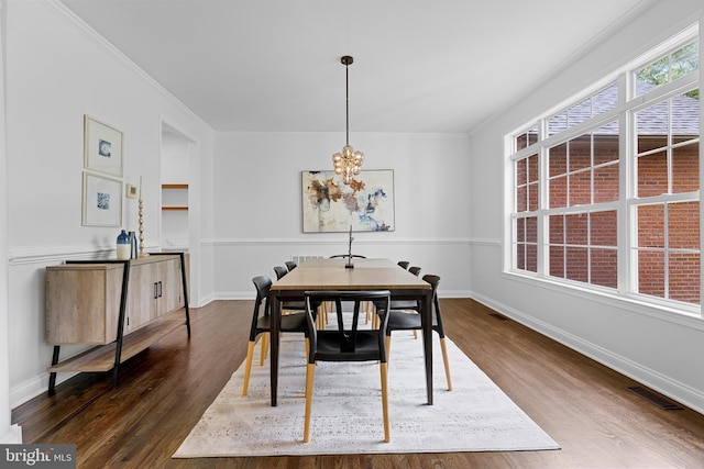 5204 Muirfield Dr, Ijamsville, MD 21754 - dining space featuring a chandelier, dark wood-style floors, ornamental molding, and baseboards
