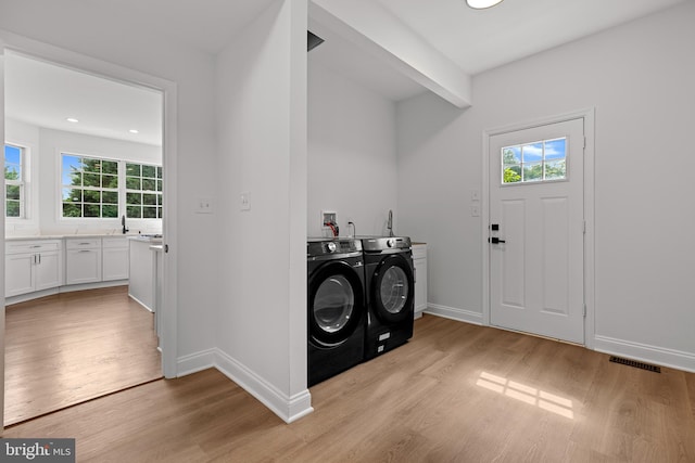 5204 Muirfield Dr, Ijamsville, MD 21754 - laundry area featuring washing machine and clothes dryer, plenty of natural light, light wood-style floors, and recessed lighting