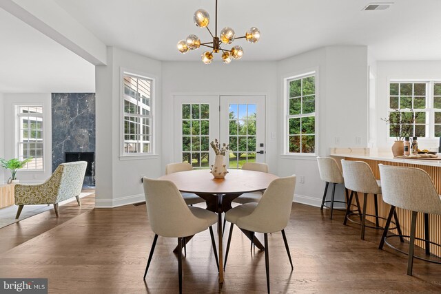 5204 Muirfield Dr, Ijamsville, MD 21754 - dining area with a chandelier, baseboards, dark wood-type flooring, and a premium fireplace