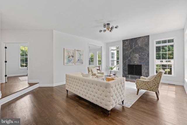 5204 Muirfield Dr, Ijamsville, MD 21754 - living area with wood finished floors, baseboards, a high end fireplace, and a chandelier