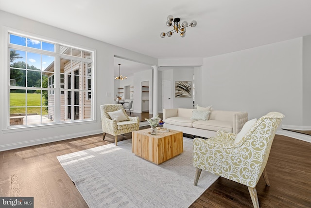 5204 Muirfield Dr, Ijamsville, MD 21754 - living room featuring wood finished floors, a chandelier, baseboards, and ornate columns