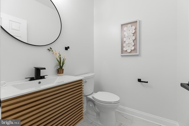 5204 Muirfield Dr, Ijamsville, MD 21754 - half bathroom featuring marble look tiles, toilet, vanity, and baseboards
