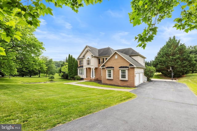 5204 Muirfield Dr, Ijamsville, MD 21754 - view of front of property featuring brick siding, a garage, a front yard, and driveway