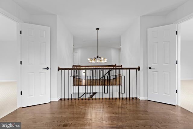 5204 Muirfield Dr, Ijamsville, MD 21754 - hallway with an upstairs landing, a chandelier, wood finished floors, and baseboards