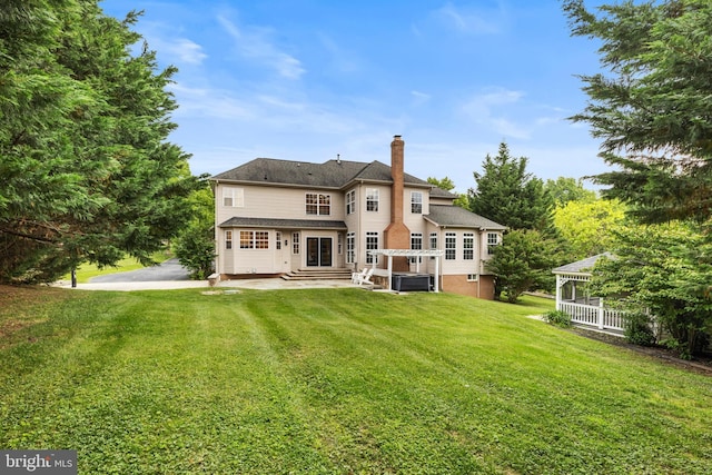 5204 Muirfield Dr, Ijamsville, MD 21754 - rear view of property with a chimney, a lawn, and a gazebo