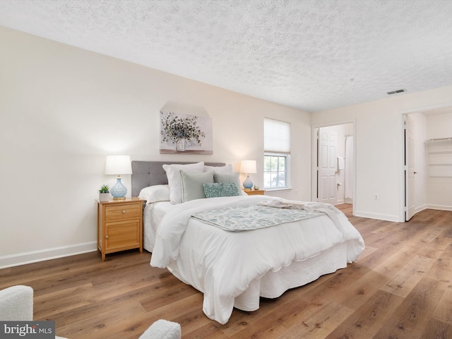 621 Admiral Dr Unit 207, Annapolis, MD 21401 - bedroom with light wood finished floors, baseboards, and a textured ceiling